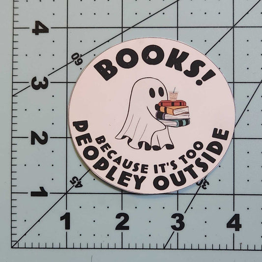Circular sticker with text and graphics on a cutting mat with grid lines