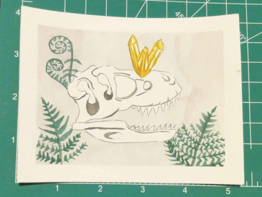 Small white paper with a design on a green cutting mat