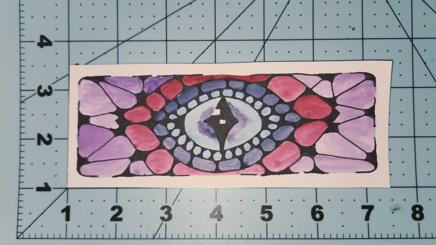 Colorful mandala design on a piece of paper with a ruler for scale.