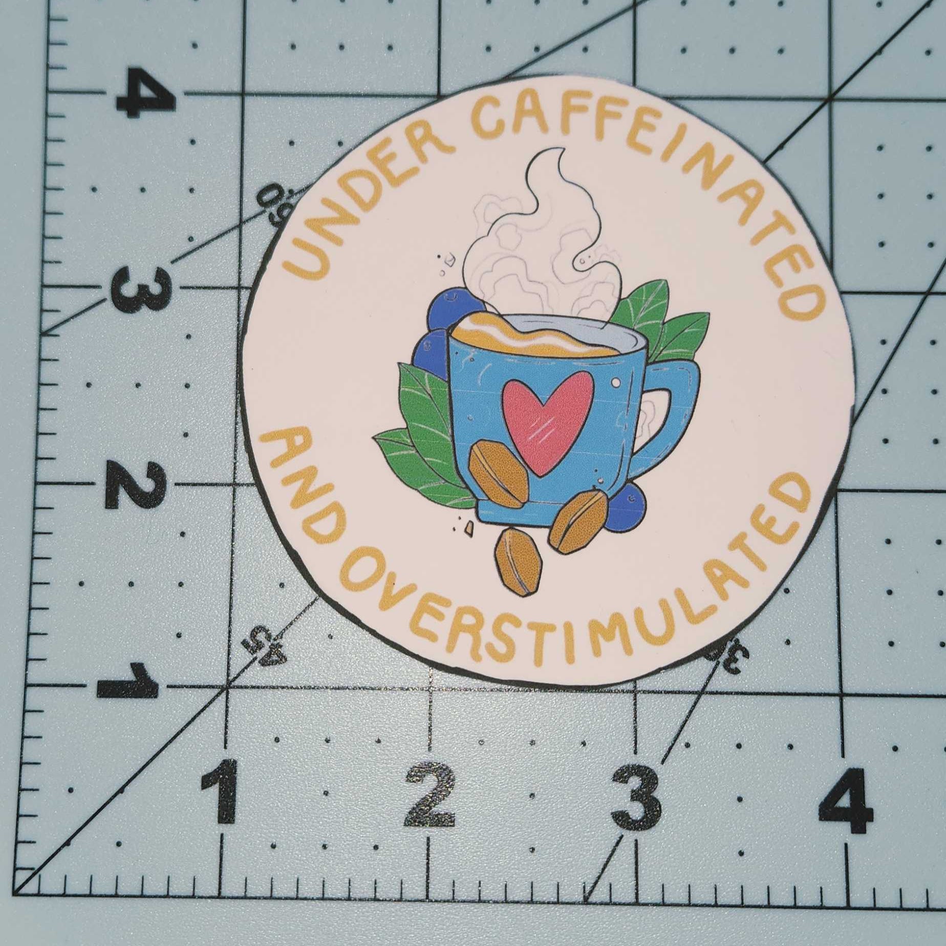 Round sticker with colorful design on a cutting mat
