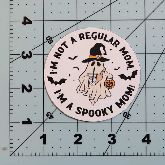 Circular sticker with text and graphic on a cutting mat with ruler
