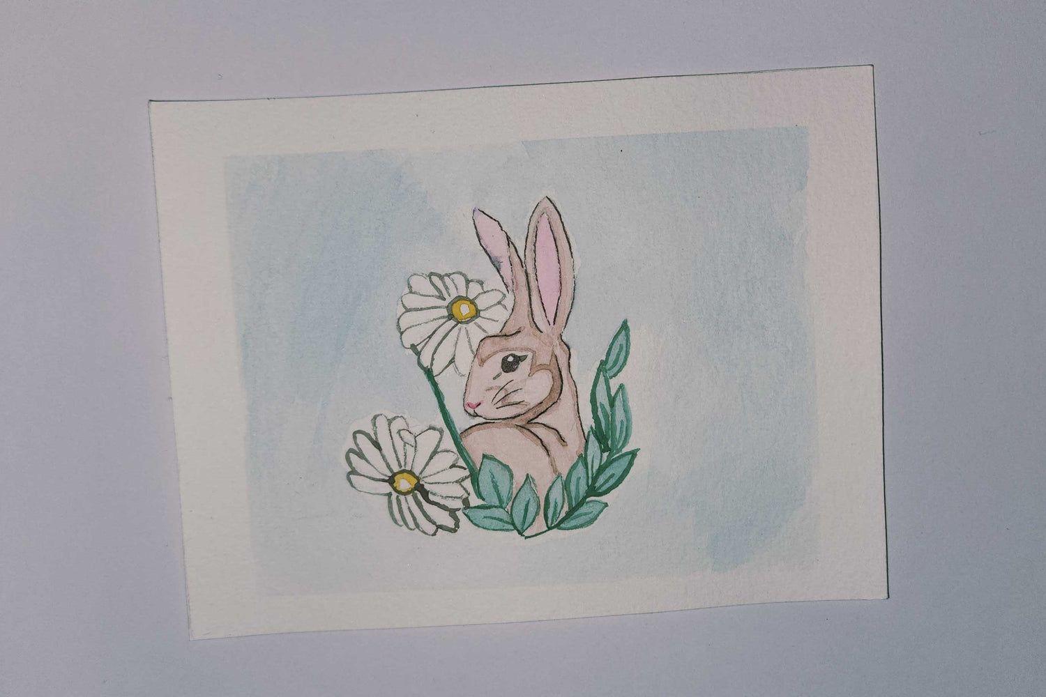 Illustration of a bunny with flowers on a white background