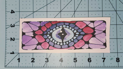 Colorful mandala design on a piece of paper with a ruler for scale.