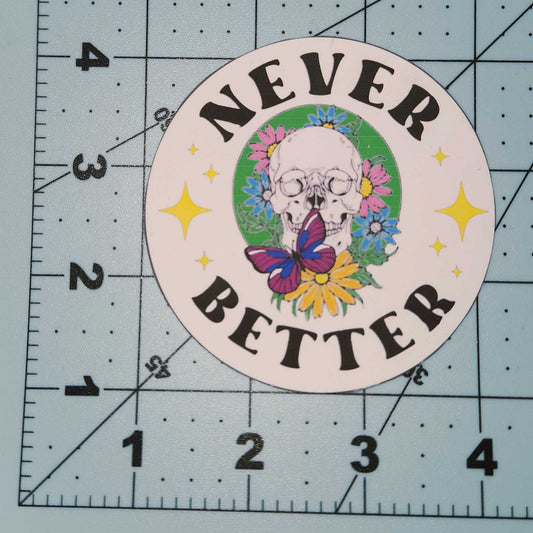 Circular sticker with 'Never Better' text on a cutting mat